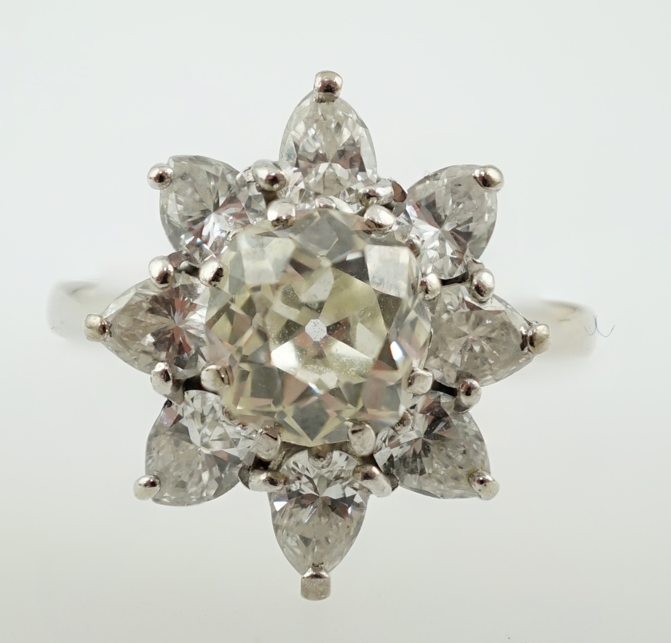 A modern 18ct white gold and diamond flower head cluster ring